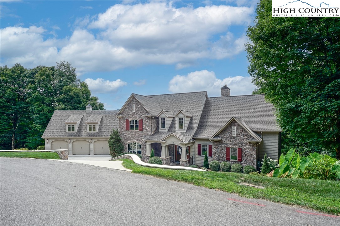 879 Winding Ridge Drive West Jefferson, NC 28694 - Photo 3 of 37 a front view of a house with a garden and yard