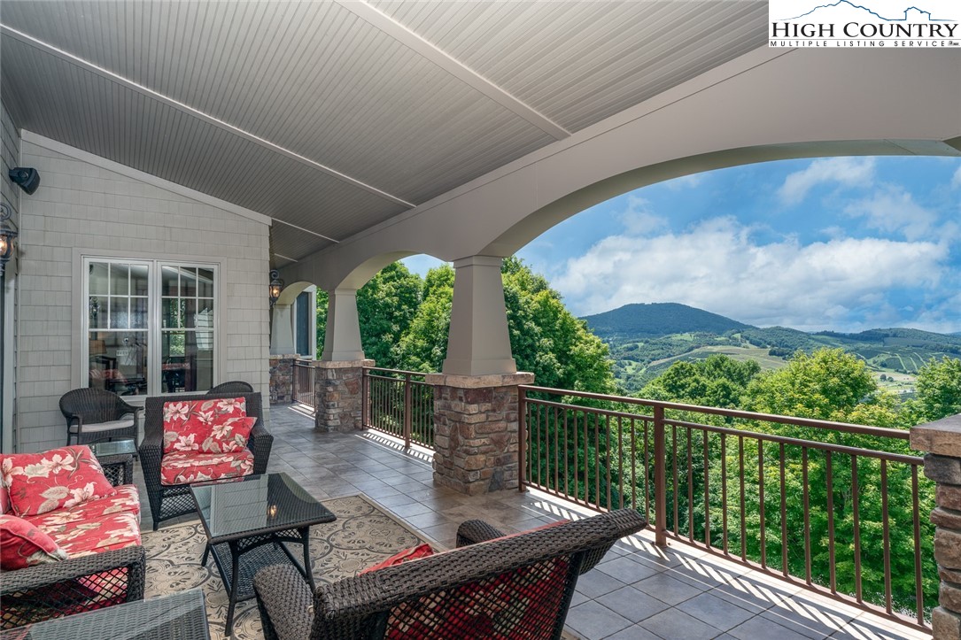 879 Winding Ridge Drive West Jefferson, NC 28694 - Photo 8 of 37 a view of a chairs and table in the balcony