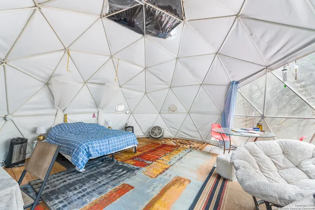 a yellow house with a trees in the background