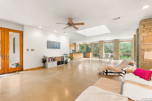 a living room with furniture and large windows