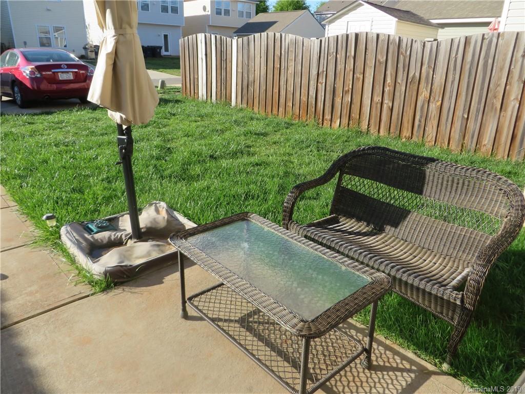 12315 Cross Meadow Road Huntersville, NC 28078 - Photo 11 of 12 a wooden bench sitting in front of a house