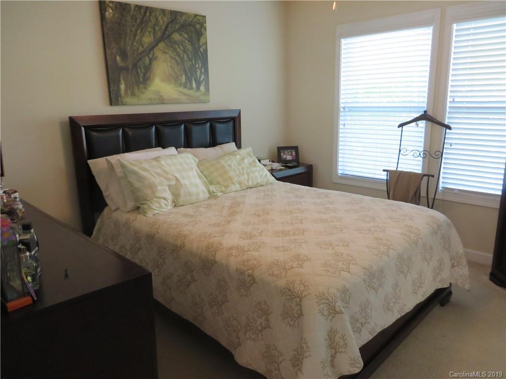 12315 Cross Meadow Road Huntersville, NC 28078 - Photo 6 of 12 a bed sitting in a bedroom next to a window