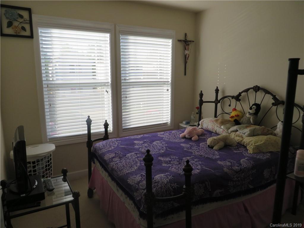 12315 Cross Meadow Road Huntersville, NC 28078 - Photo 8 of 12 a bedroom with a bed and large windows