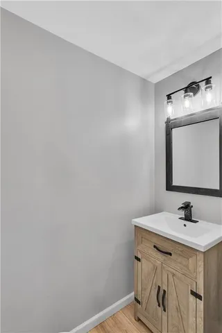 a bathroom with a sink vanity and a mirror