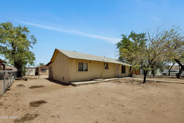 a backyard of a house with a tree