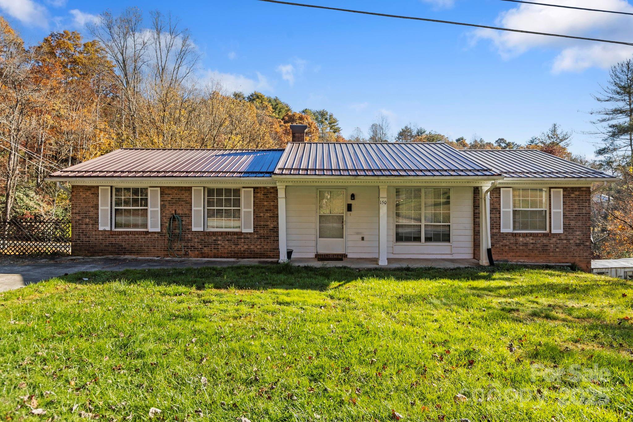 150 Trent Road Brevard, NC 28712 - Photo 1 of 22 a front view of a house with a garden