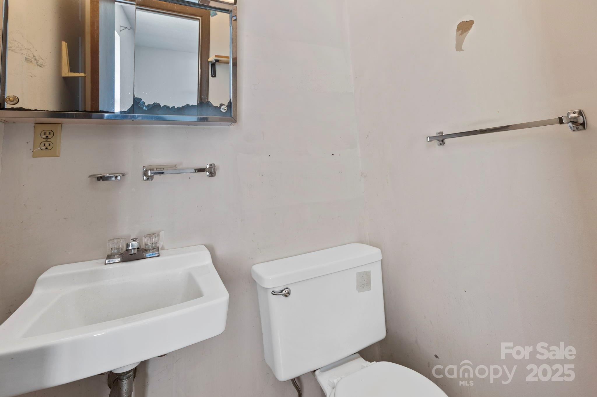150 Trent Road Brevard, NC 28712 - Photo 13 of 22 a bathroom with a toilet sink and mirror