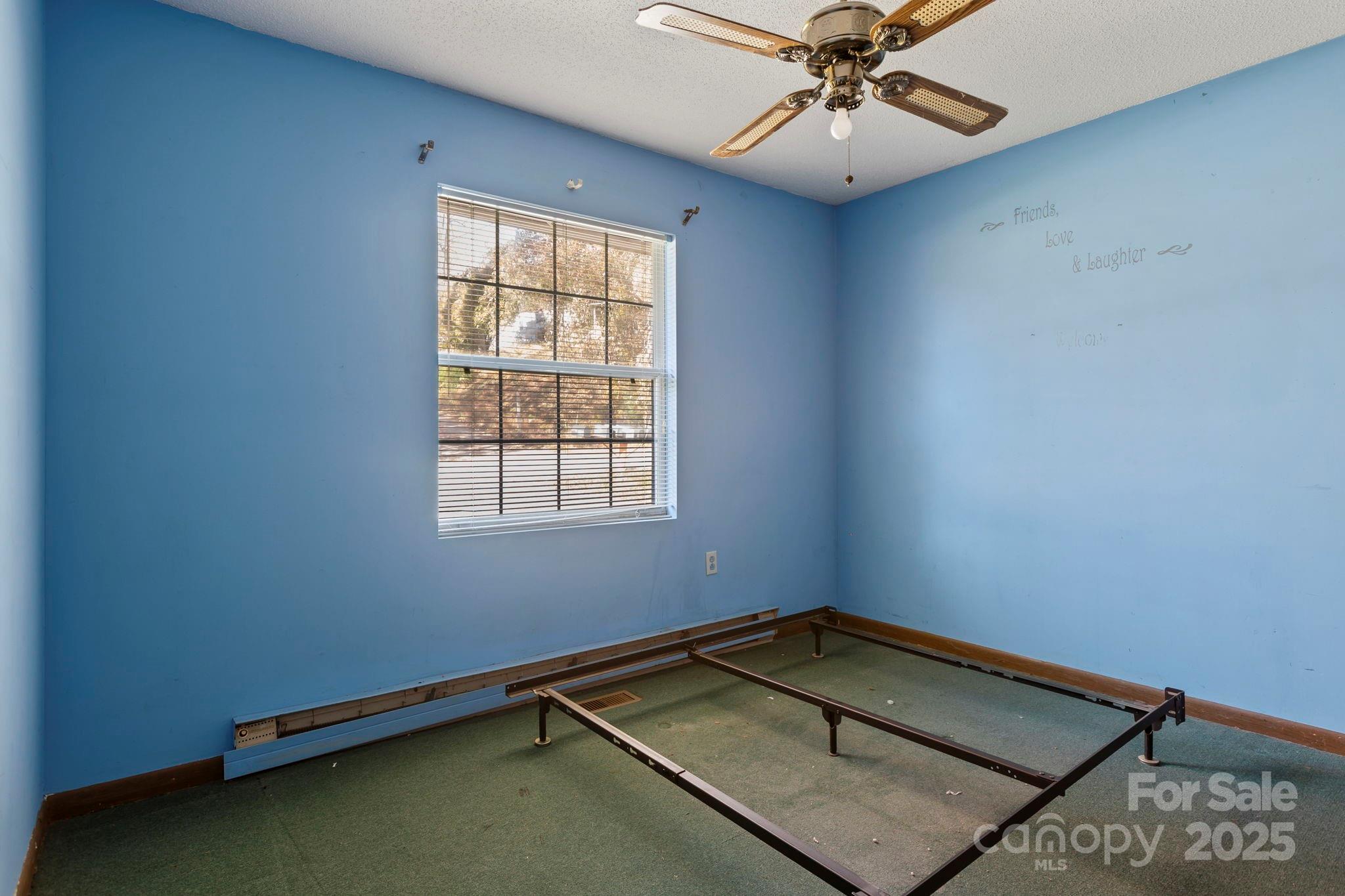 150 Trent Road Brevard, NC 28712 - Photo 14 of 22 an empty room with a window and a ceiling fan