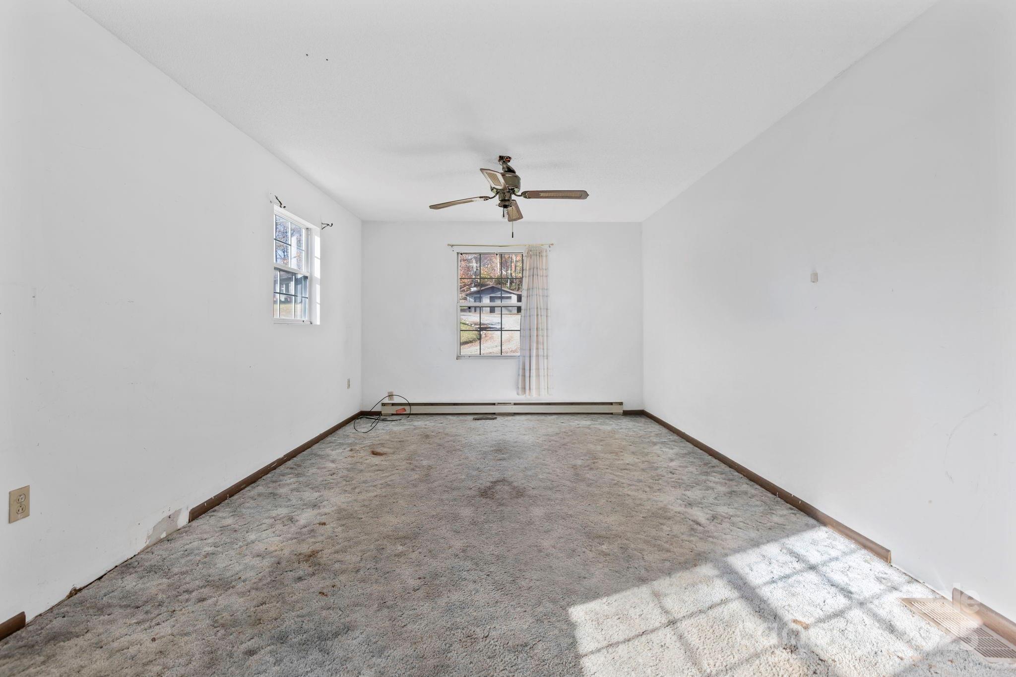 150 Trent Road Brevard, NC 28712 - Photo 22 of 22 an empty room with windows and ceiling fan