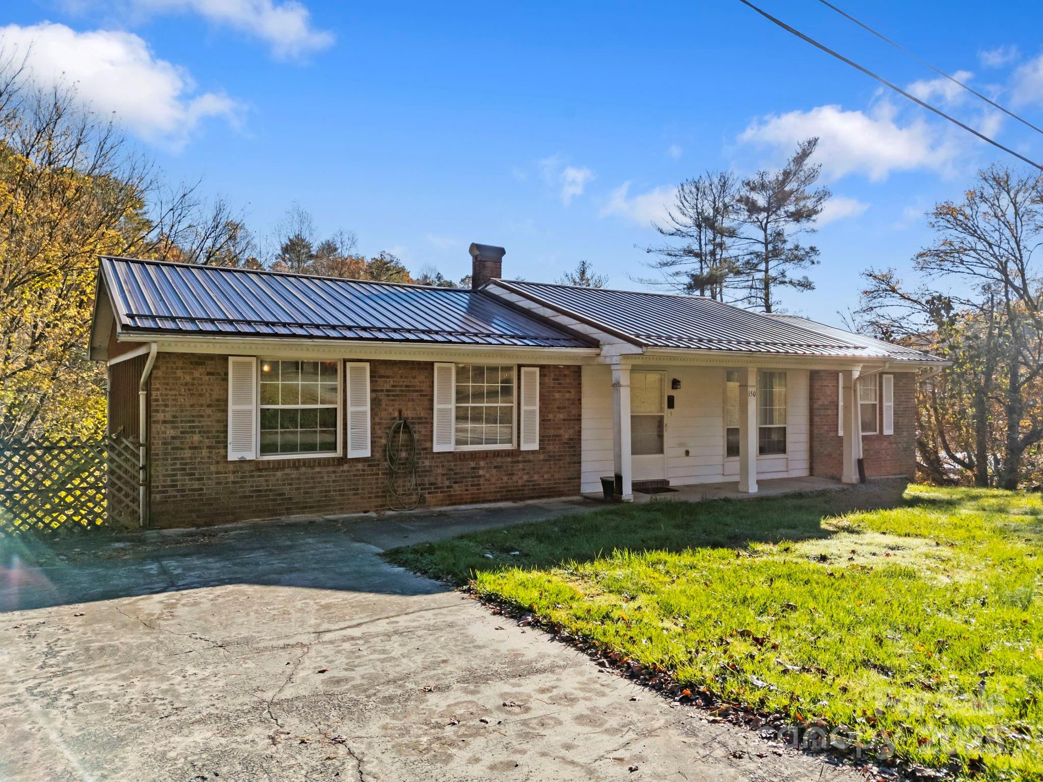150 Trent Road Brevard, NC 28712 - Photo 3 of 22 a front view of a house with a yard