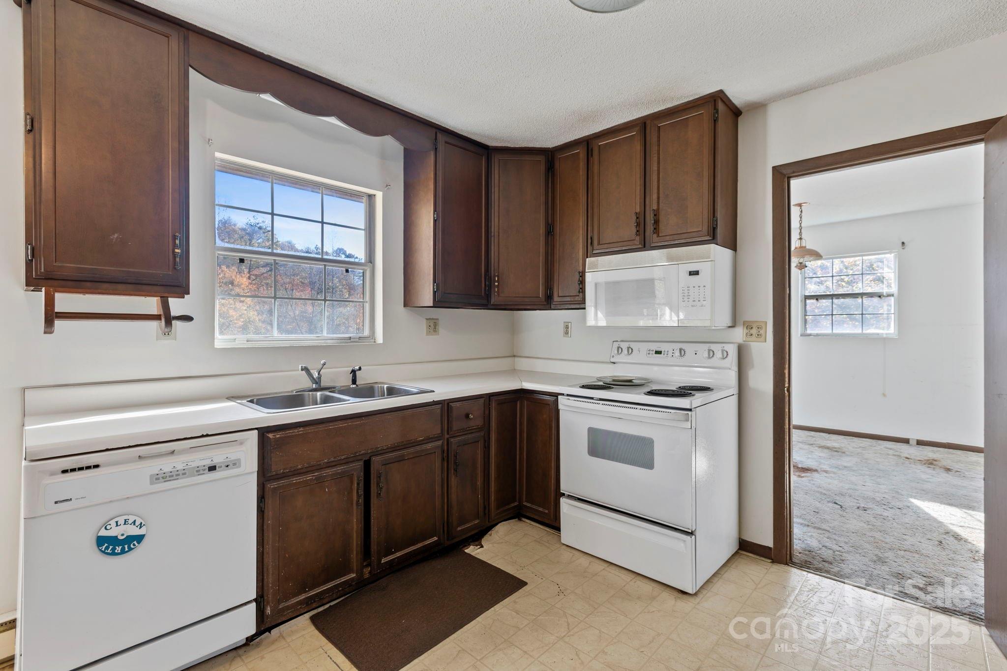 150 Trent Road Brevard, NC 28712 - Photo 9 of 22 a kitchen with a stove sink and cabinets