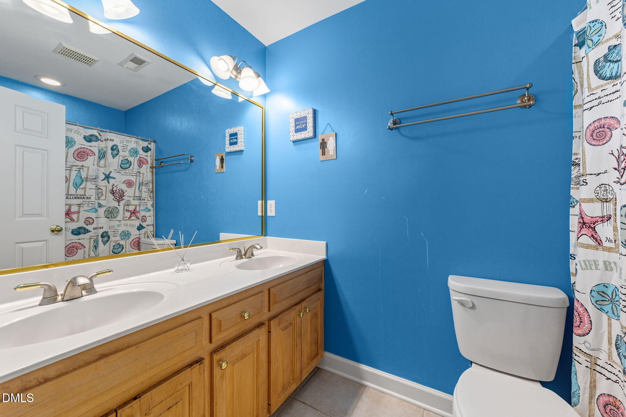 1617 Kendall Hill Road Willow Spring, NC 27592 - Photo 54 of 58 a bathroom with a toilet a sink and mirror