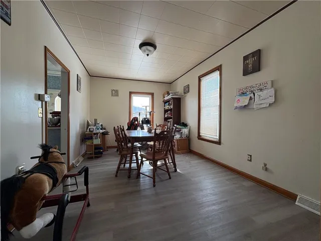 a view of a dining room with furniture and window