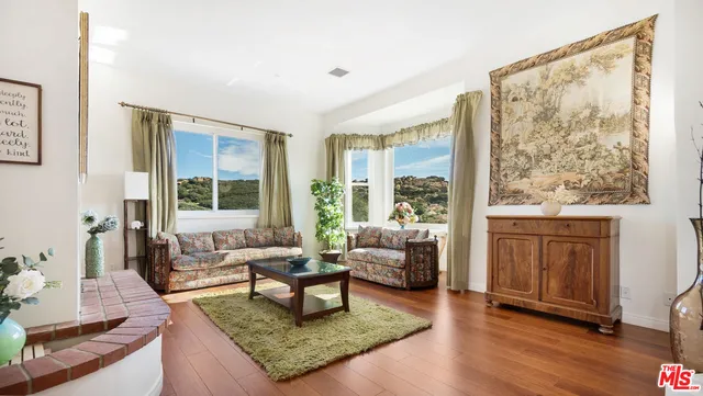 a kitchen with stainless steel appliances white cabinets a sink and a stove