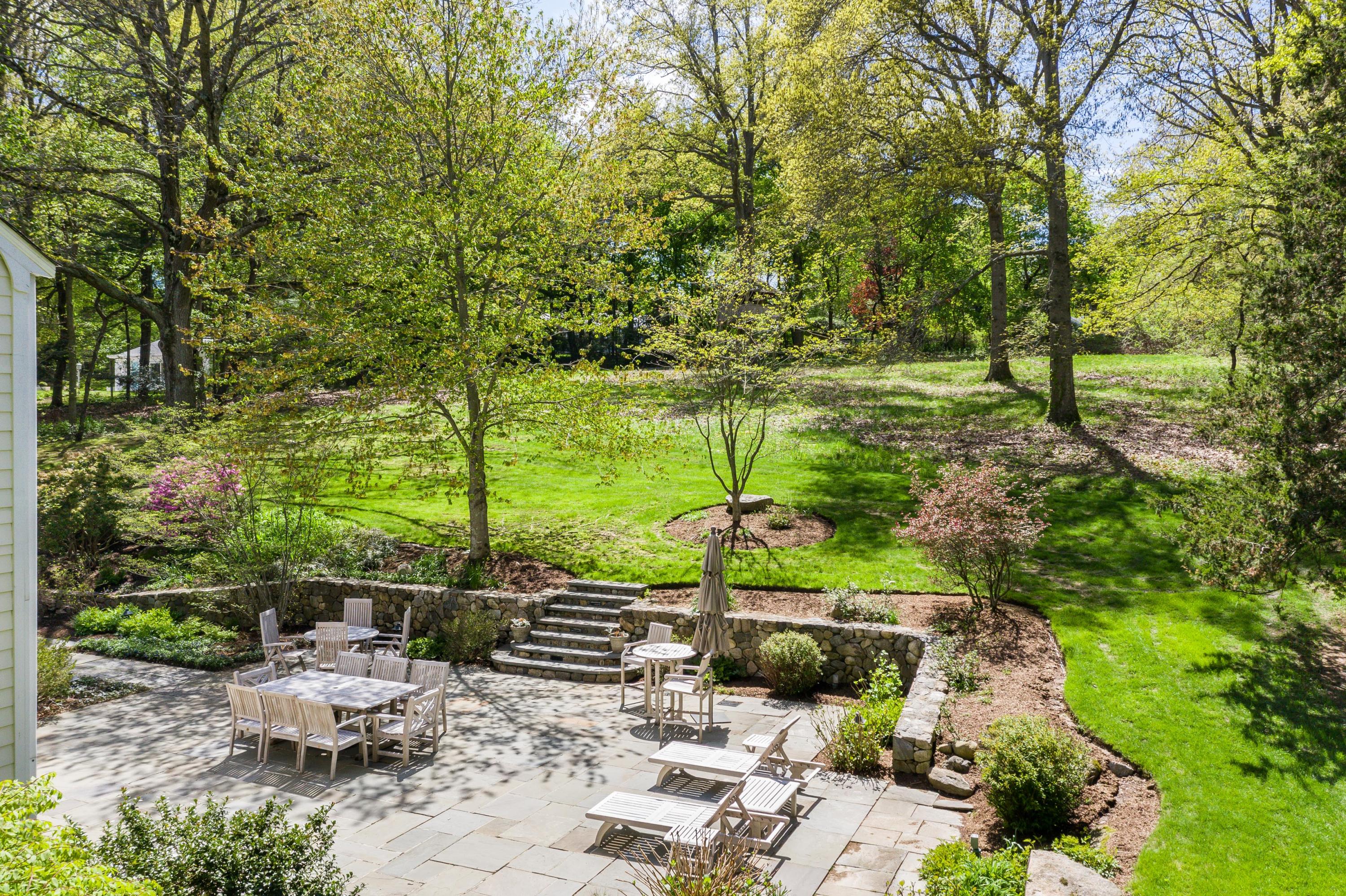 55 Maywood Road Darien, CT 06820 - Photo 20 of 23 a view of a chair and tables in the garden