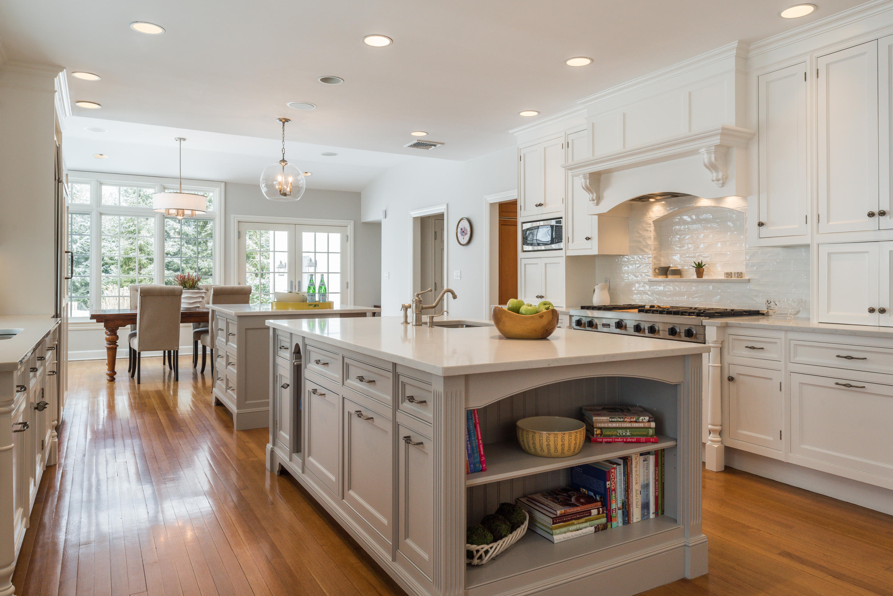 55 Maywood Road Darien, CT 06820 - Photo 3 of 23 a kitchen with stainless steel appliances granite countertop a table chairs stove a sink dishwasher and cabinets with wooden floor