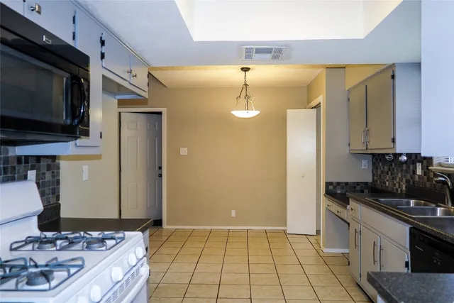 a kitchen with a sink and cabinets