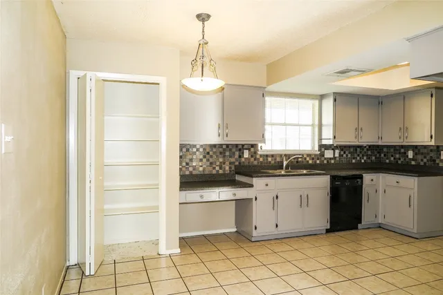 a kitchen with granite countertop white cabinets and white appliances
