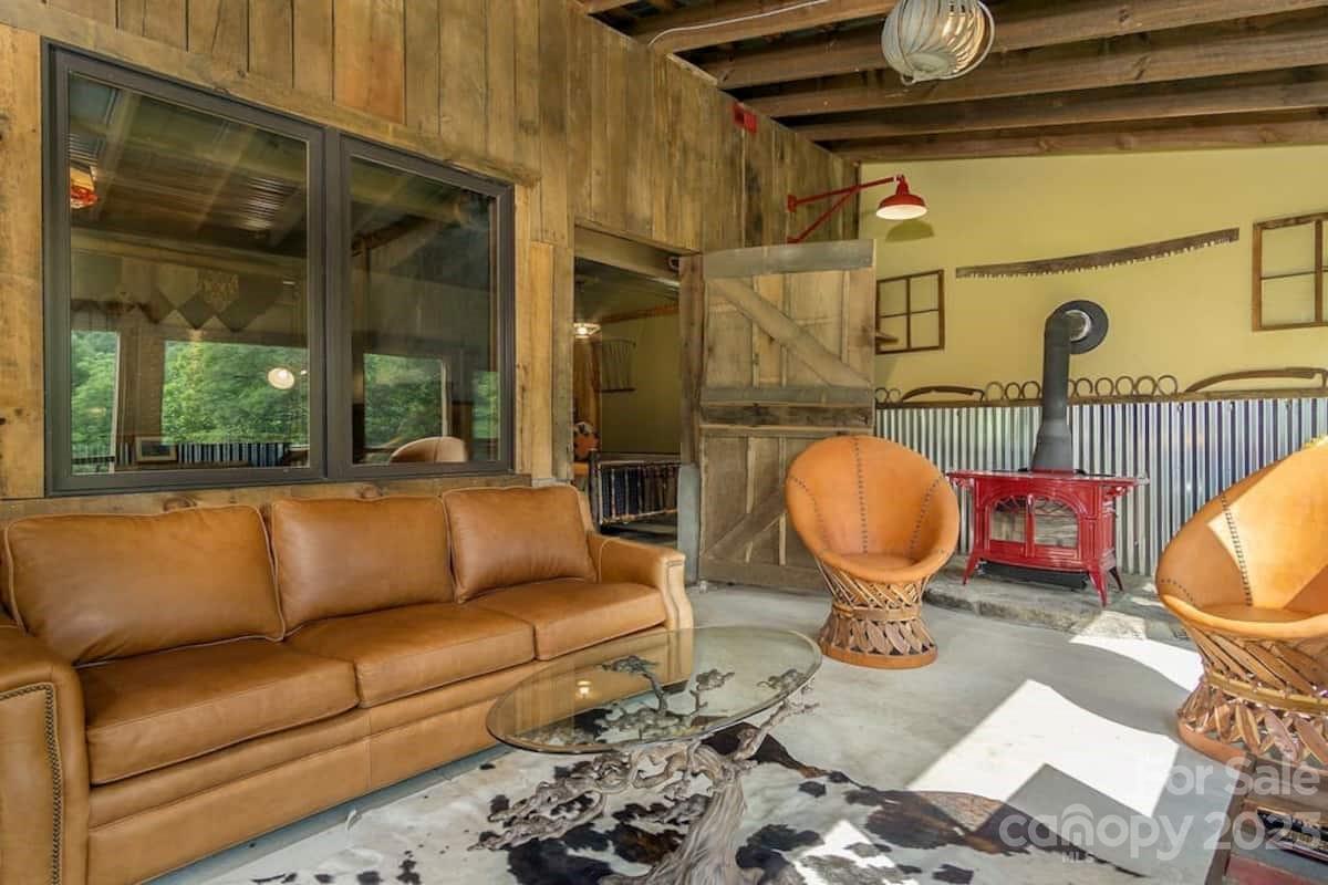 72 Scotchmans Road Waynesville, NC 28786 - Photo 13 of 46 a living room with furniture a rug and a floor to ceiling window