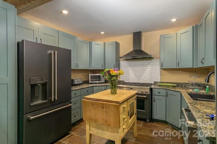 72 Scotchmans Road Waynesville, NC 28786 - Photo 16 of 46 a kitchen with stainless steel appliances granite countertop a refrigerator stove and sink