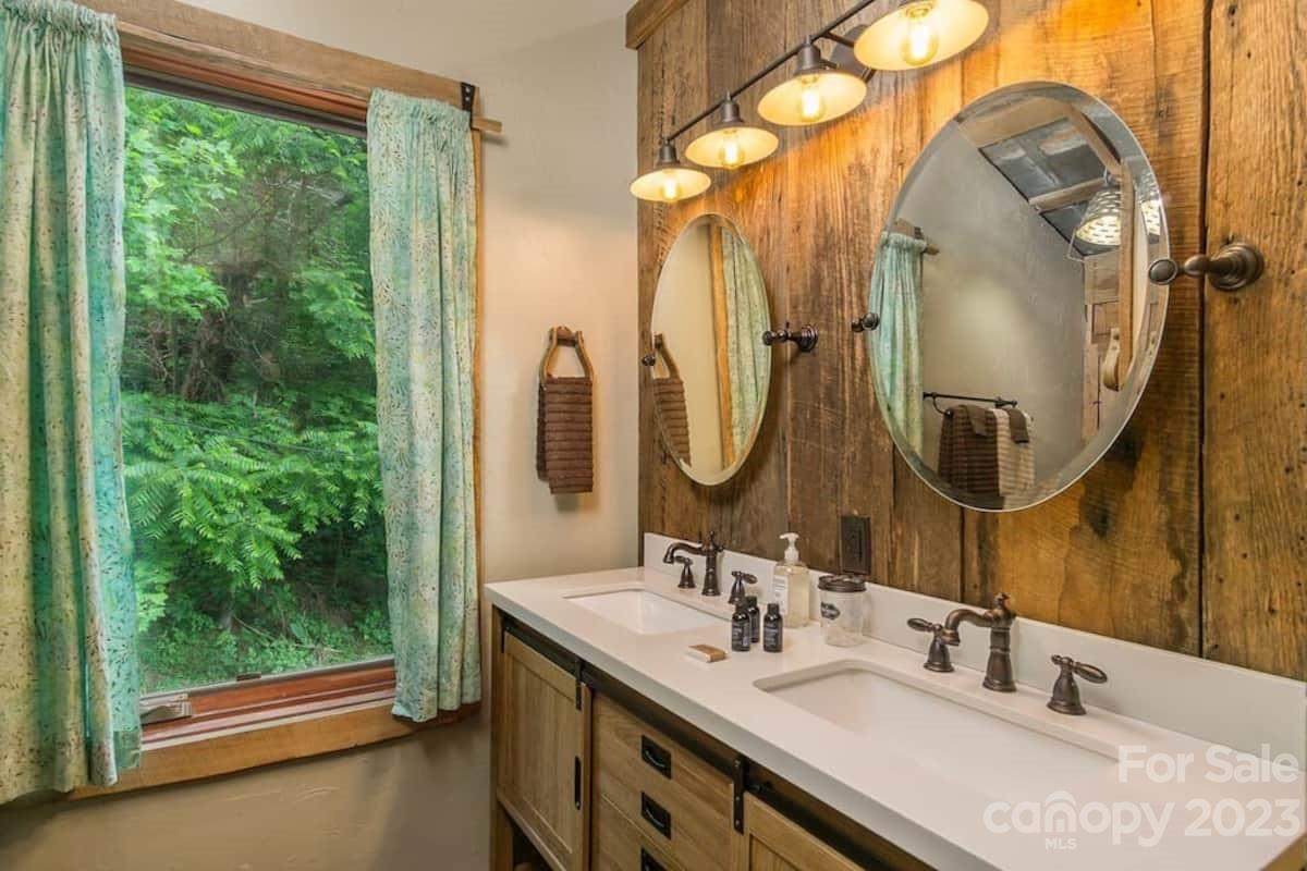 72 Scotchmans Road Waynesville, NC 28786 - Photo 21 of 46 a bathroom with a double vanity sink and a mirror