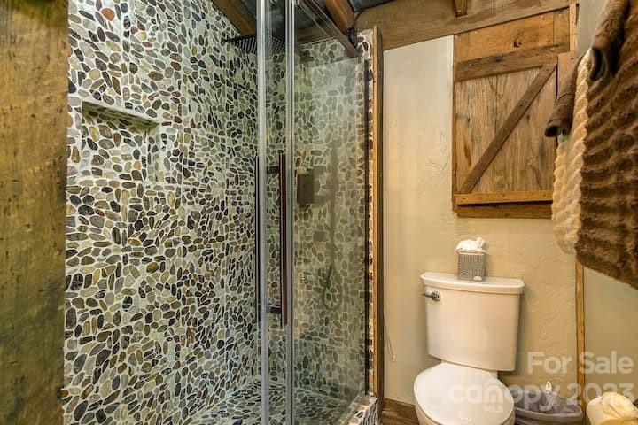 72 Scotchmans Road Waynesville, NC 28786 - Photo 22 of 46 a bathroom with a toilet and a shower curtain