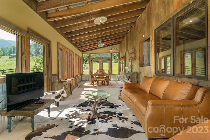 72 Scotchmans Road Waynesville, NC 28786 - Photo 29 of 46 a living room with furniture and a floor to ceiling window