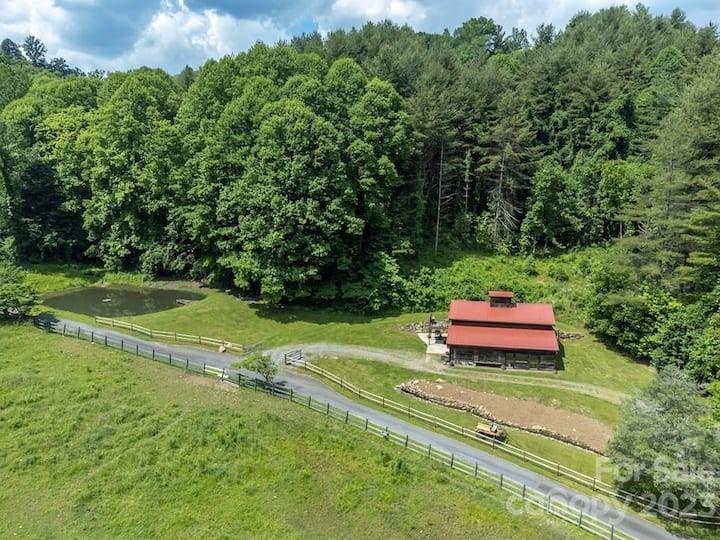 72 Scotchmans Road Waynesville, NC 28786 - Photo 3 of 46 a view of a small yard with a barn and large trees