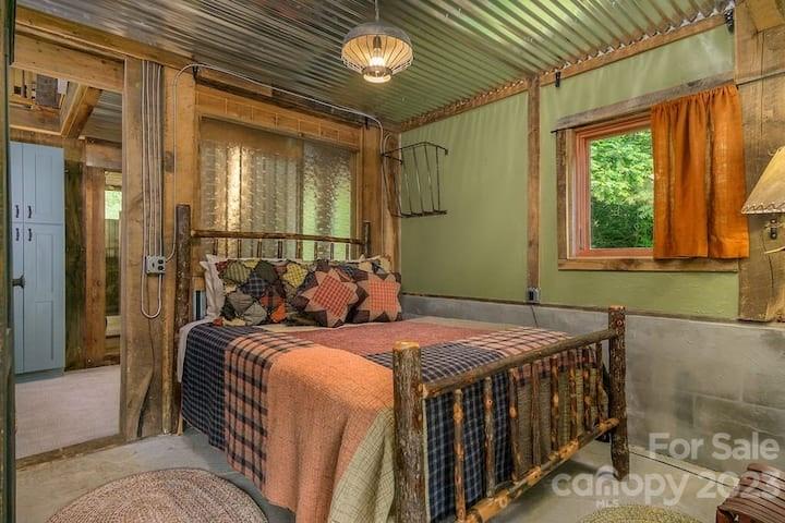 72 Scotchmans Road Waynesville, NC 28786 - Photo 36 of 46 a bedroom with a bed and a window