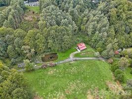 72 Scotchmans Road Waynesville, NC 28786 - Photo 43 of 46 a backyard of a house with a yard and outdoor seating