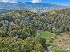 72 Scotchmans Road Waynesville, NC 28786 - Photo 44 of 46 a view of a forest with a mountain and trees