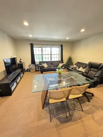 a living room with furniture pool table and a window