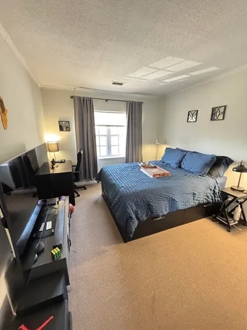 a bedroom with a bed and window