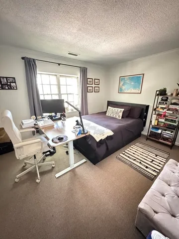 a bedroom with furniture and a window