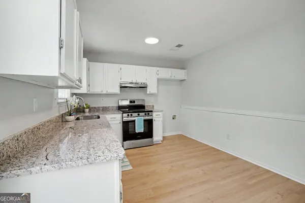 an empty room with windows and entrance