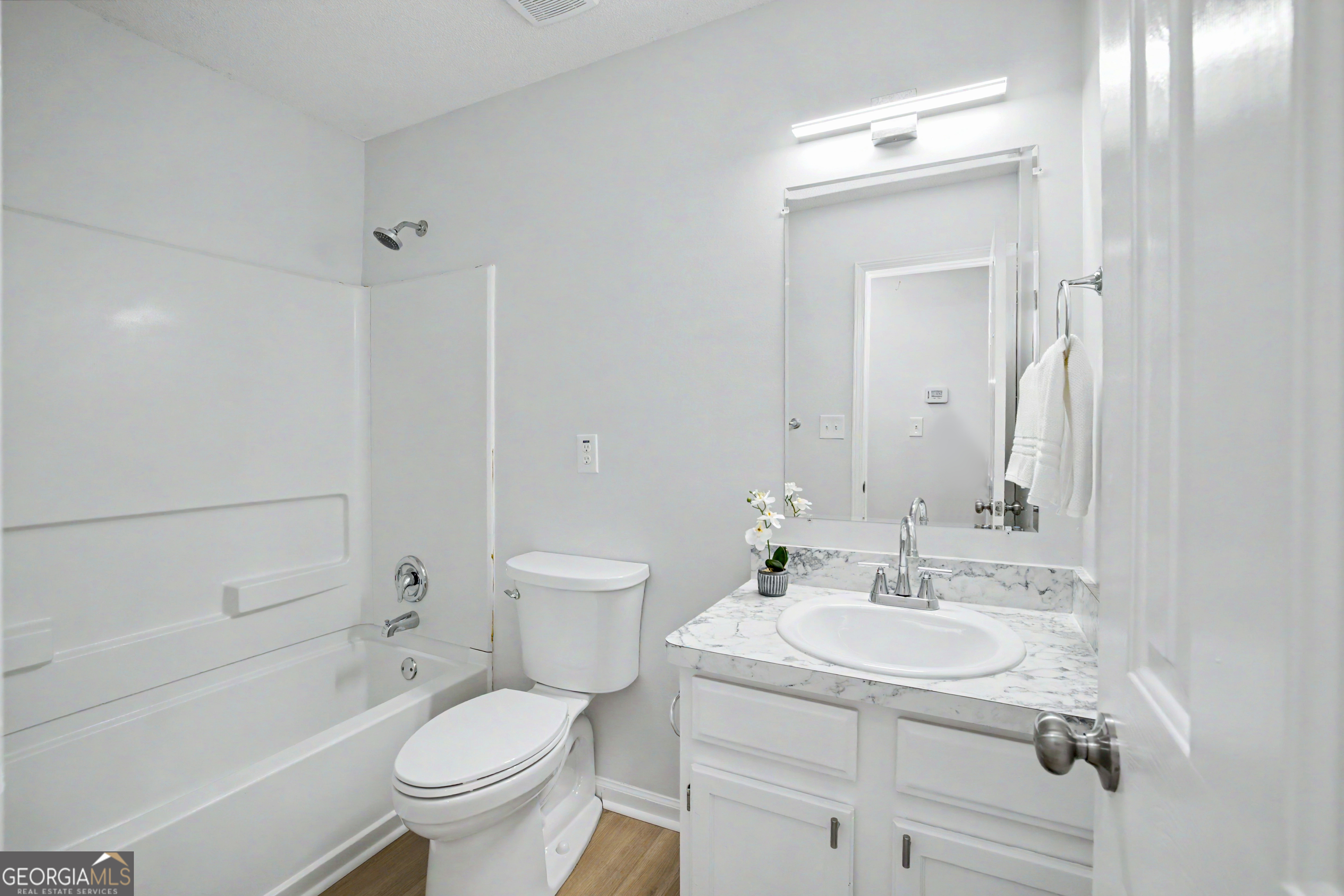 613 Coan Drive Locust Grove, GA 30248 - Photo 18 of 34 a bathroom with a sink toilet tub and shower