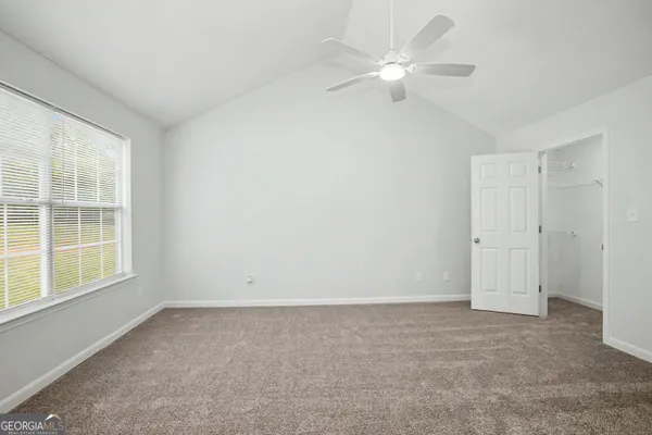 a view of an empty room and closet area