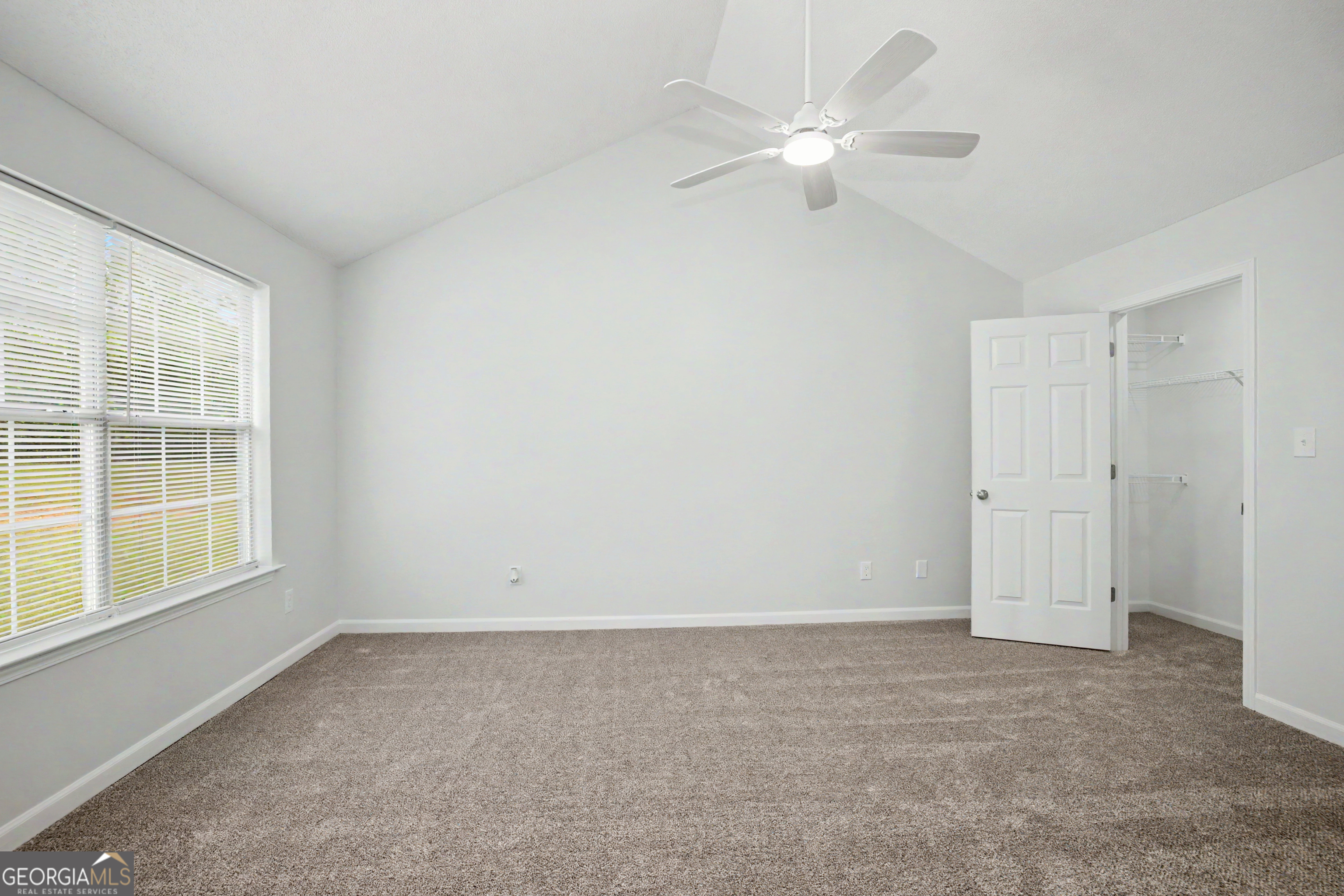 613 Coan Drive Locust Grove, GA 30248 - Photo 21 of 34 an empty room with a window and a ceiling fan