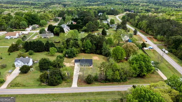 an aerial view of residential houses with outdoor space and street view