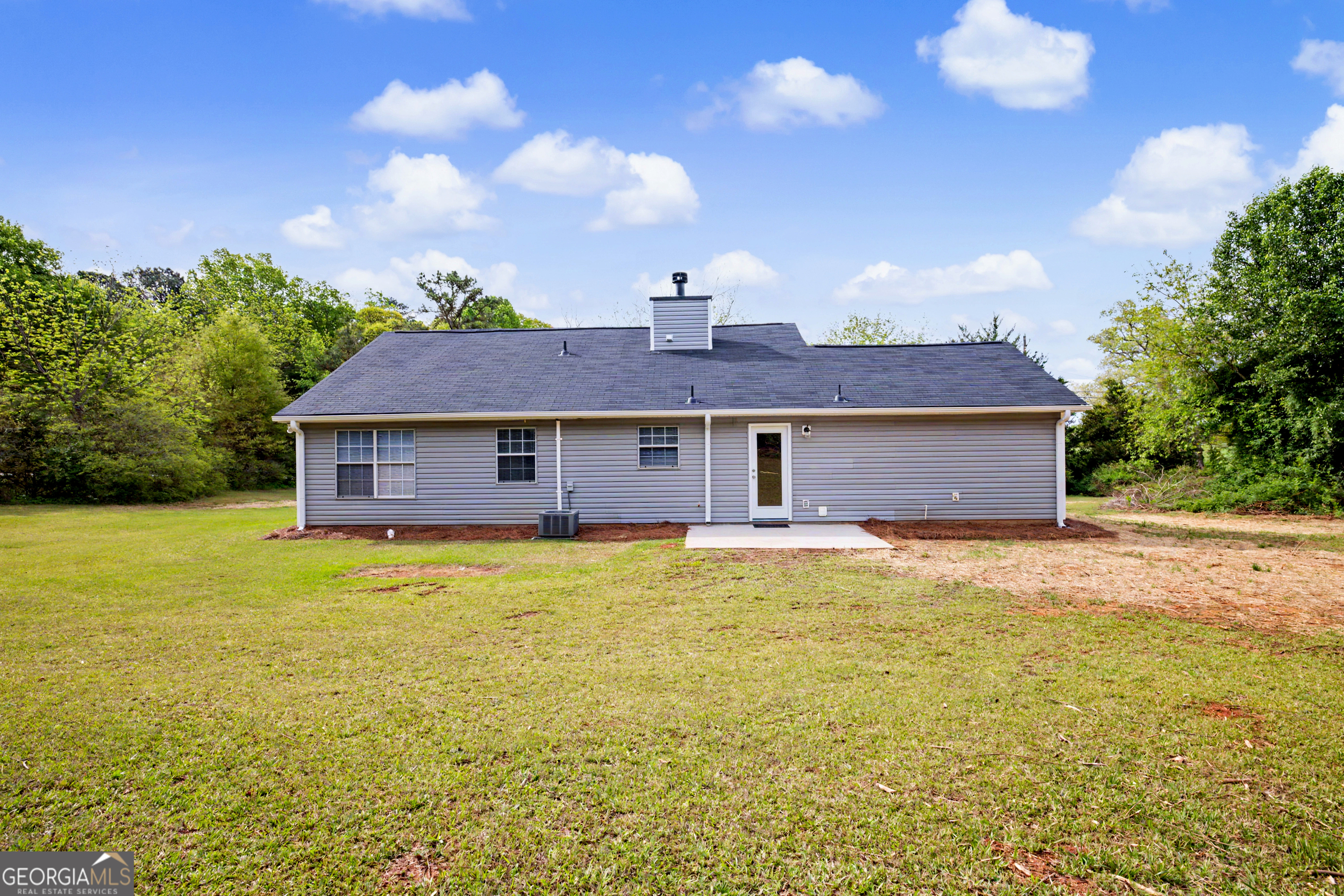 613 Coan Drive Locust Grove, GA 30248 - Photo 5 of 34 a front view of a house with a yard