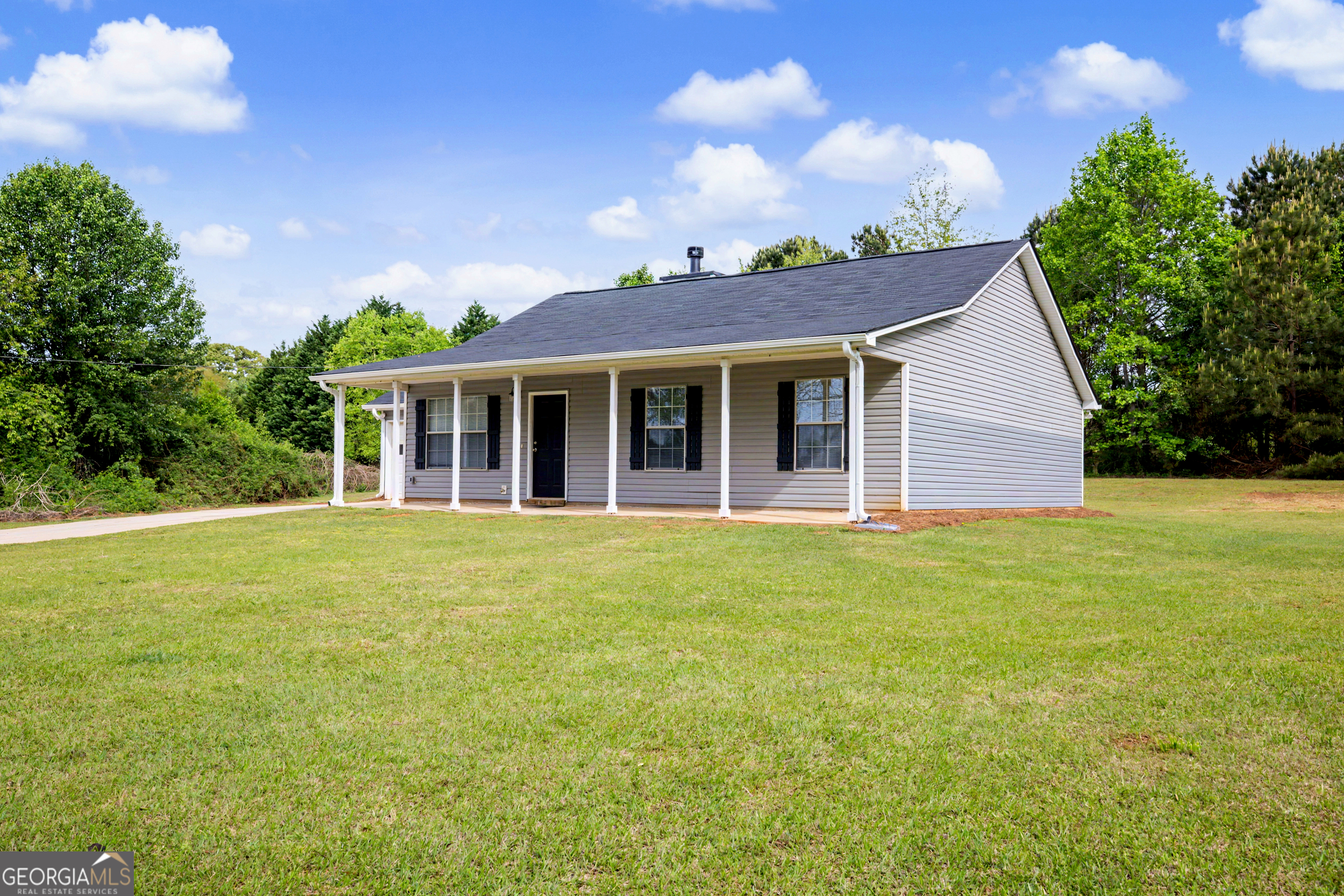 613 Coan Drive Locust Grove, GA 30248 - Photo 6 of 34 a view of a house with a backyard
