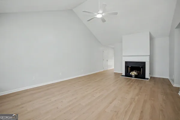 a view of an empty room with a fireplace