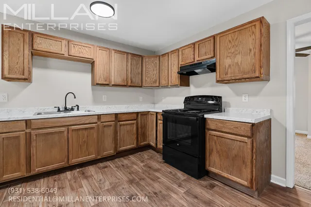 a kitchen with stainless steel appliances granite countertop a sink stove and cabinets