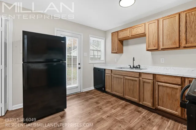 a kitchen with a refrigerator and a sink
