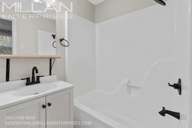 a bathroom with a sink and mirror