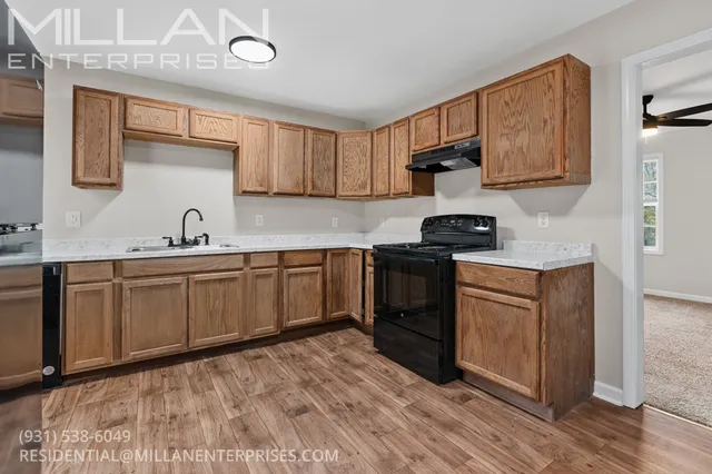 a kitchen with a sink cabinets and window