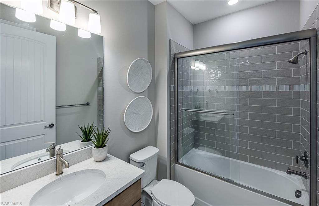 20322 Napa Loop Estero, FL 33928 - Photo 13 of 46 a bathroom with a sink toilet and shower