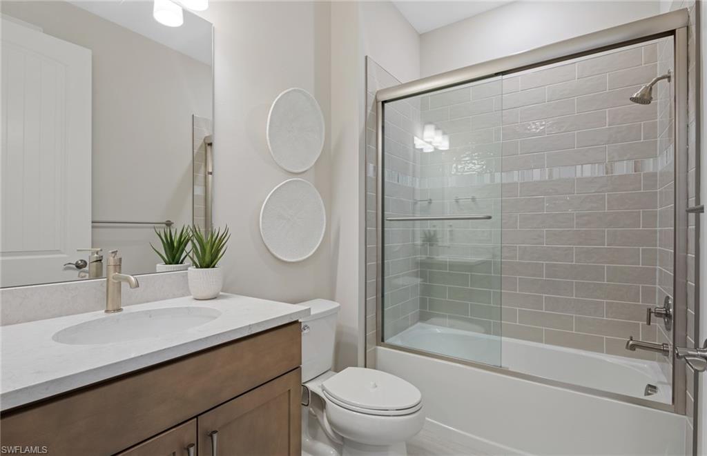 20322 Napa Loop Estero, FL 33928 - Photo 18 of 46 a bathroom with a sink a toilet and shower