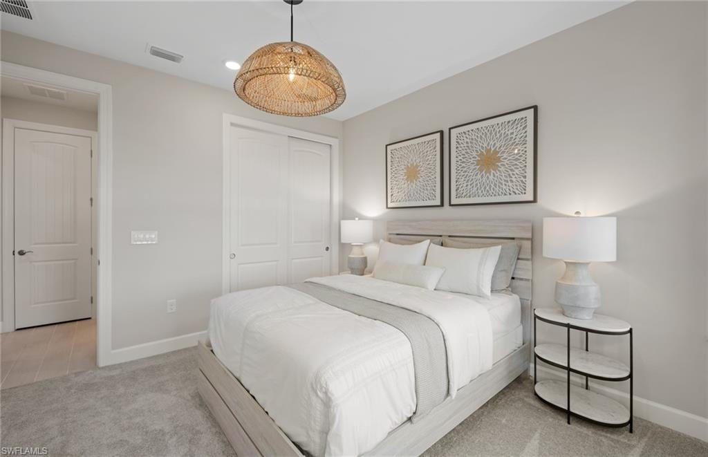 20322 Napa Loop Estero, FL 33928 - Photo 19 of 46 a bedroom with a bed and a painting