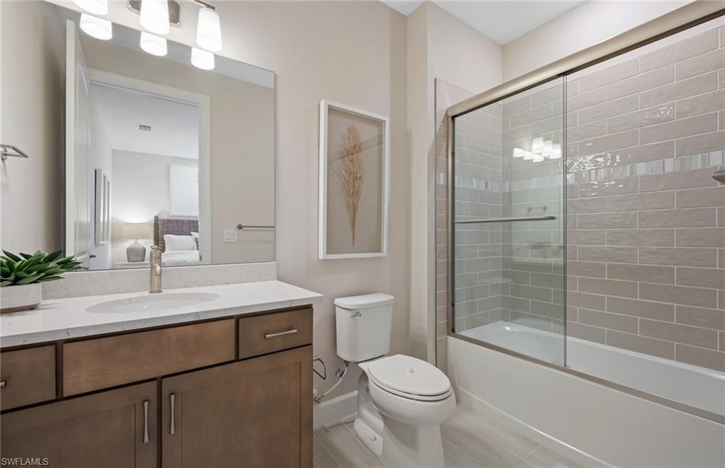 20322 Napa Loop Estero, FL 33928 - Photo 21 of 46 a bathroom with a sink a toilet and shower